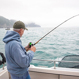 Man on boat deep sea fishing