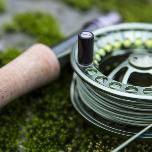A person holding a fishing rod and fishing line