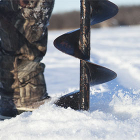 drilling a fishing hole with an auger