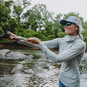 Woman fishing in shallow water