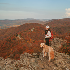 Woman hiking with her dog 